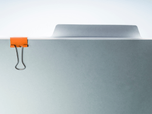 Gray file folder with orange binder clip